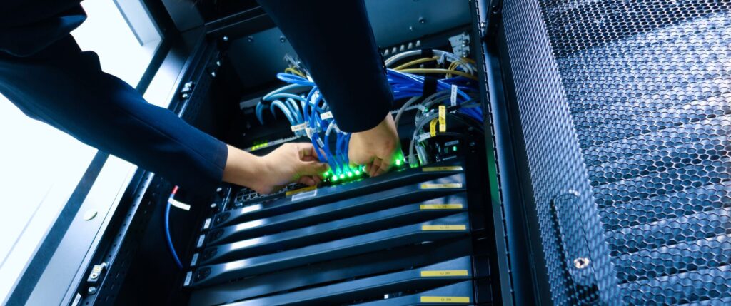 Technician Connecting Wires in Server Rack