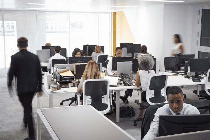 Man walking through a busy office