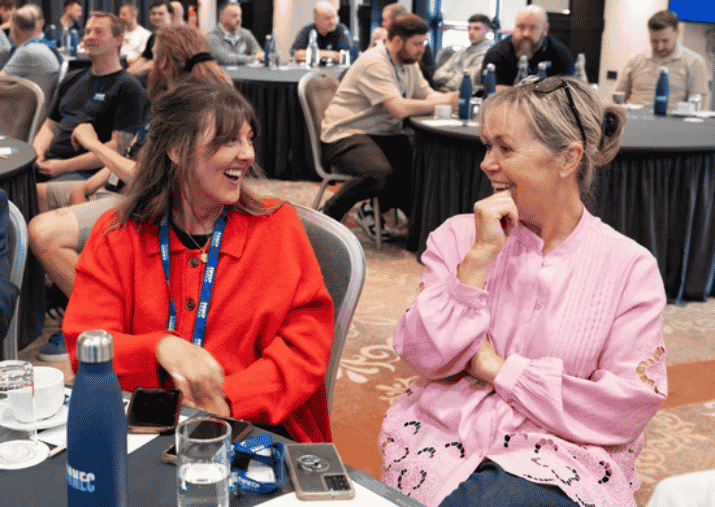 Onnec people at an event chatting and laughing